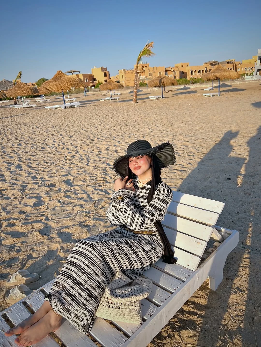 summer beach outfit for women 2026 Striped Knit Beach Dress With A Dramatic Black Hat