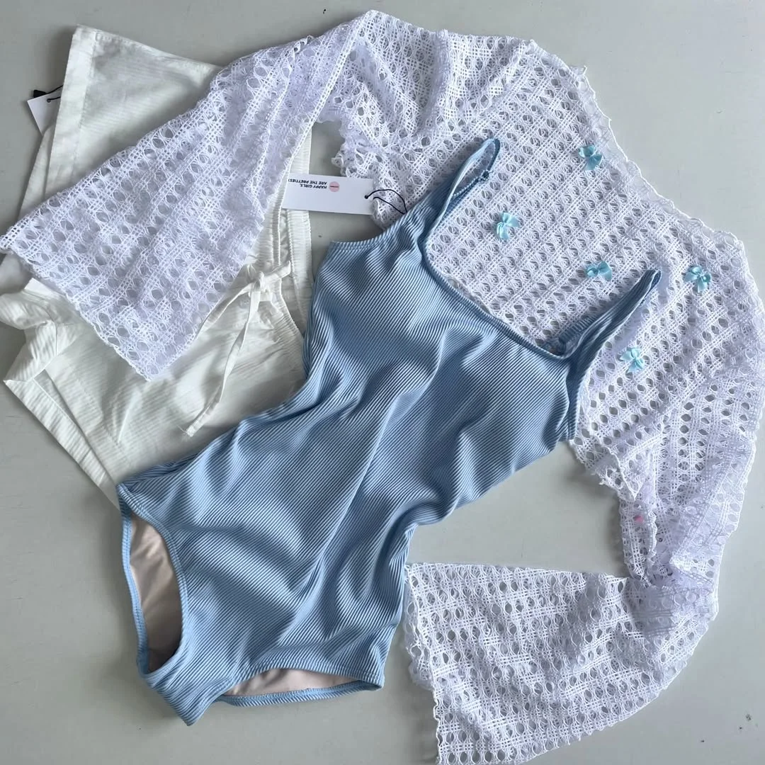 summer beach outfit for women 2026 Blue Swimsuit With A White Crochet Cover-Up