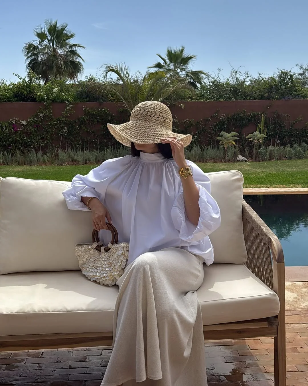 summer beach outfit for women 2026 All-White Resort Layers With A Straw Hat
