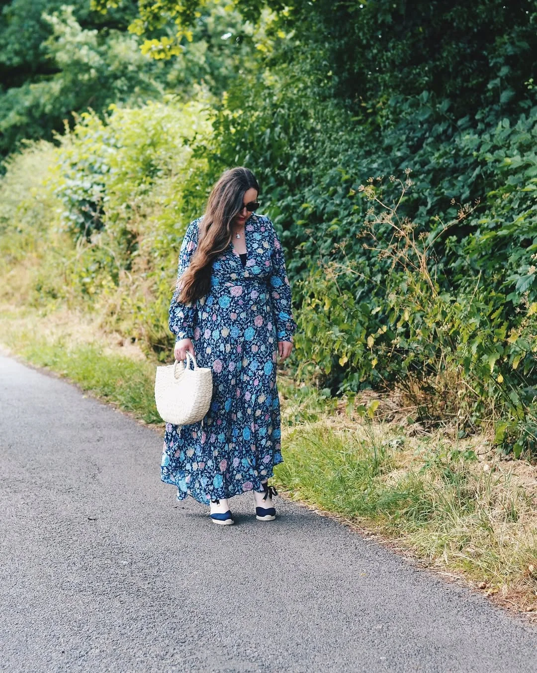 19 summer romper outfits for women 2026 Dark Floral Maxi Energy With A Woven Summer Bag