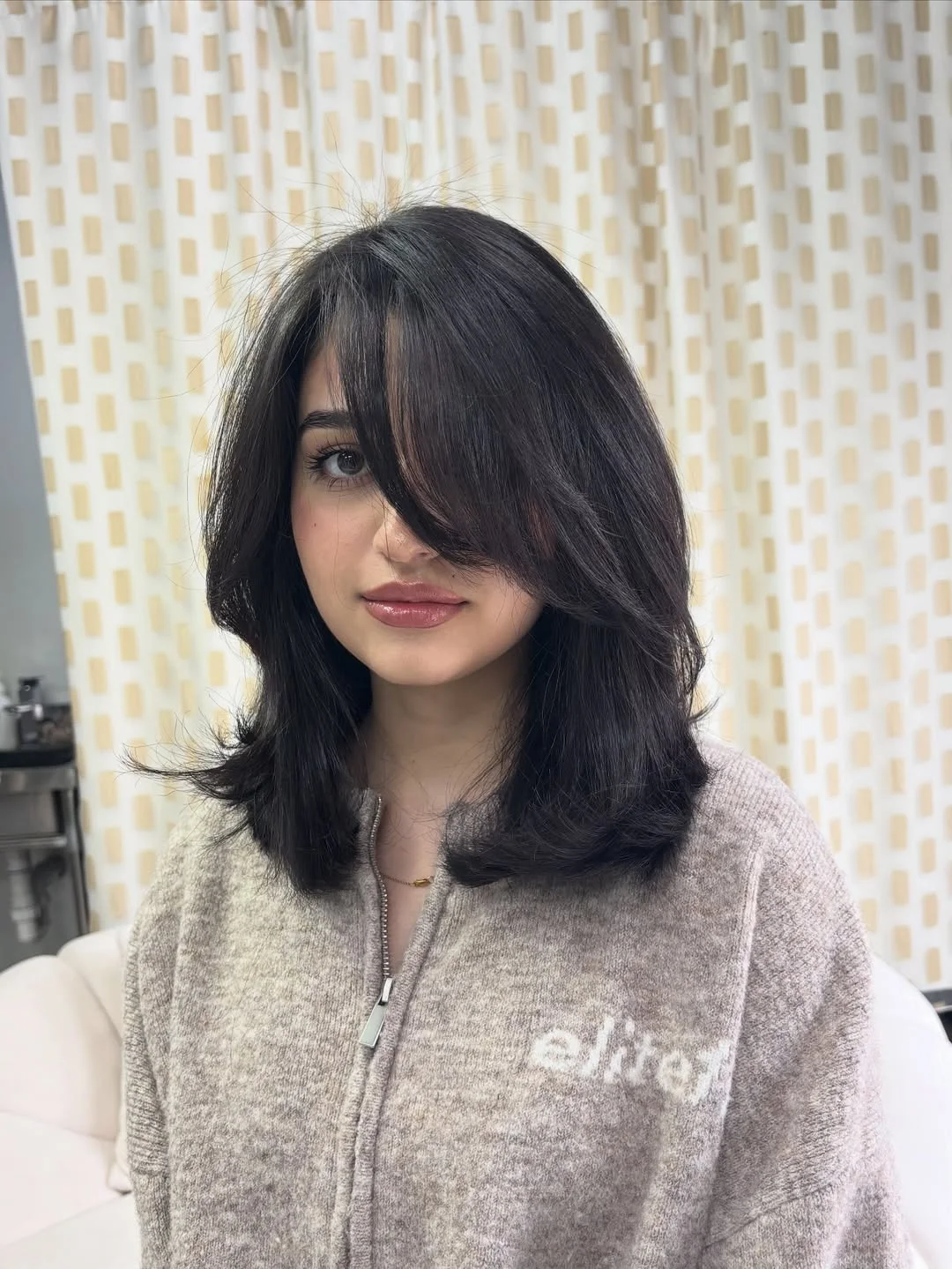 chic summer haircut 2026 Dark Butterfly Layers With a Soft Curtain Fringe