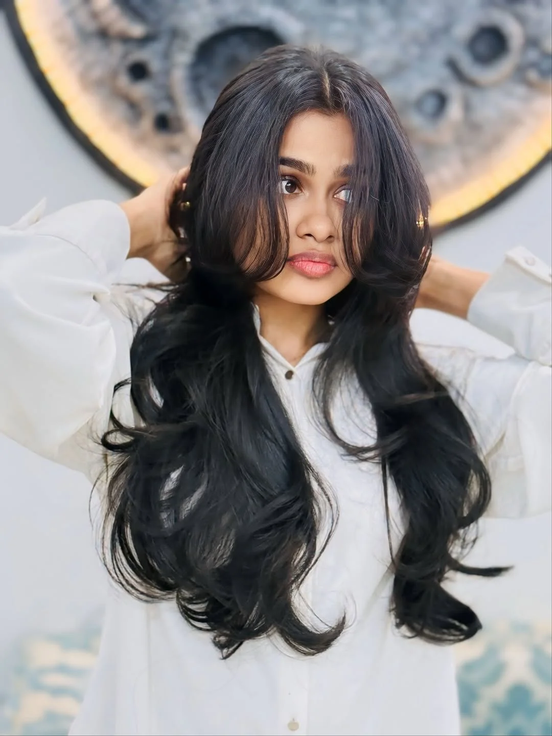 chic summer haircut 2026 Long Black Layers With a Dramatic Center-Parted Frame