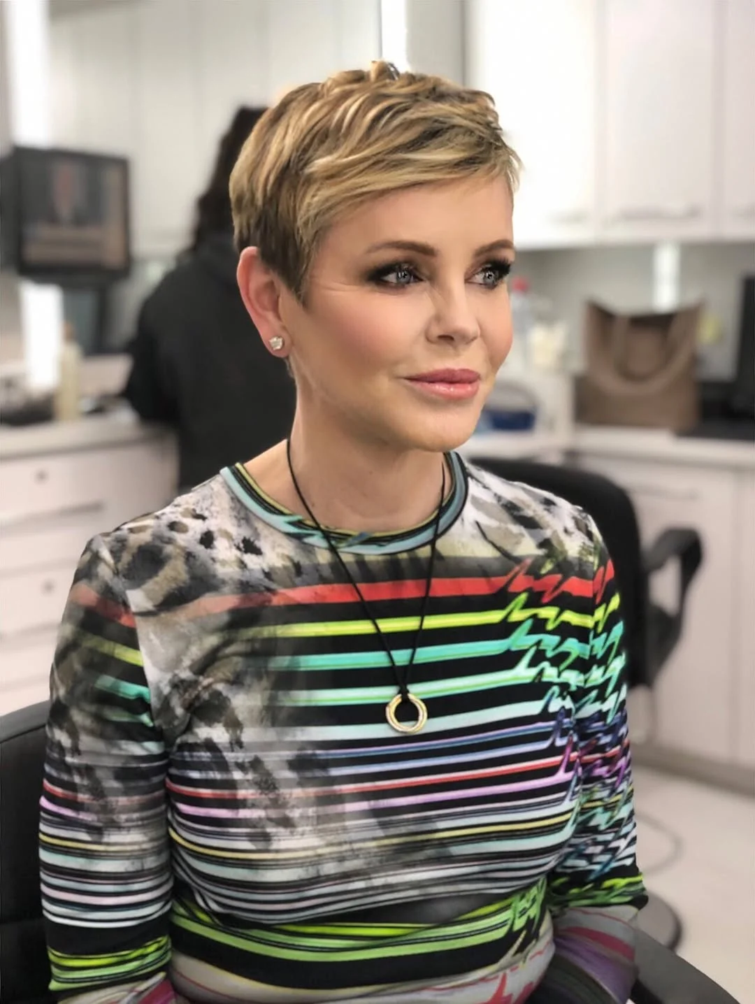 flattering summer haircuts for women over 50 2026 Chic Highlighted Pixie With Smoky Texture