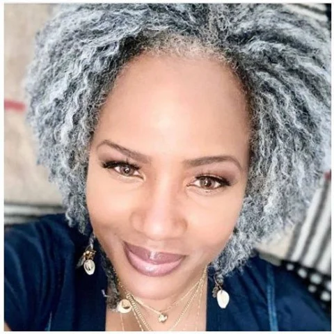 flattering summer haircuts for women over 50 2026 Soft Silver Curly Halo With Natural Volume