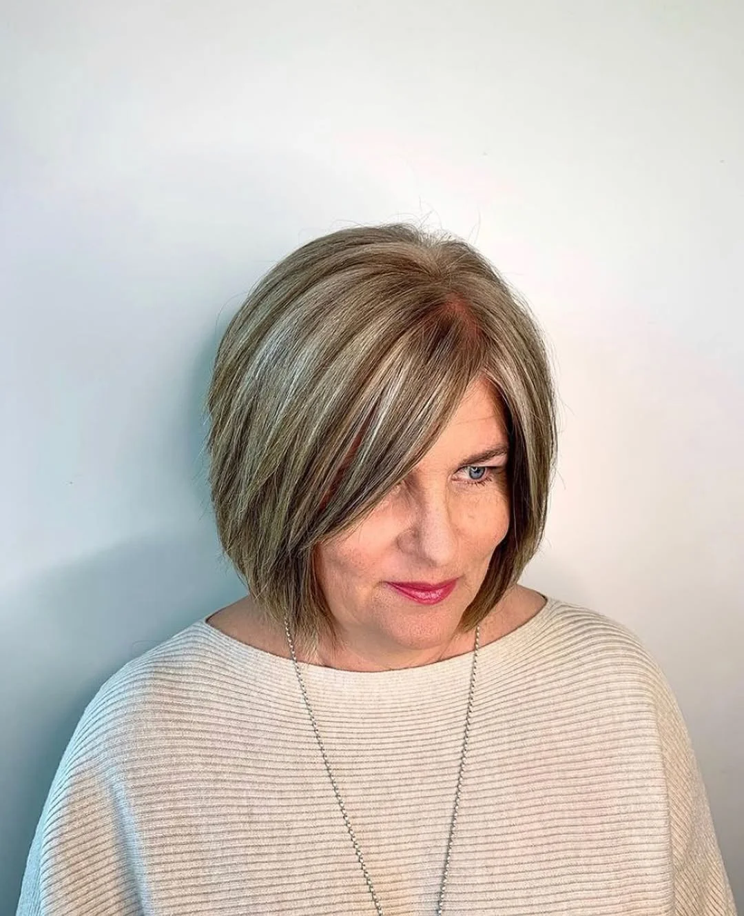 flattering summer haircuts for women over 50 2026 Face-Framing Blonde Bob With Long Side Sweep