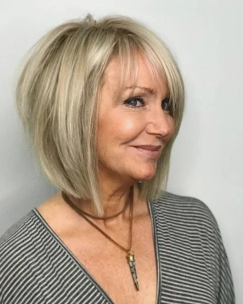 flattering summer haircuts for women over 50 2026 Classic Chin-Length Bob With Wispy Bangs