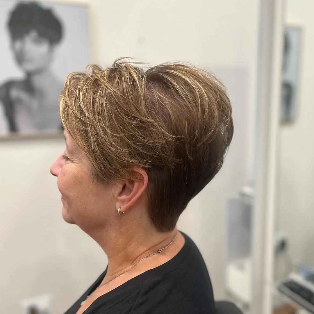 flattering summer haircuts for women over 50 2026 Soft Highlighted Pixie With Feathered Volume