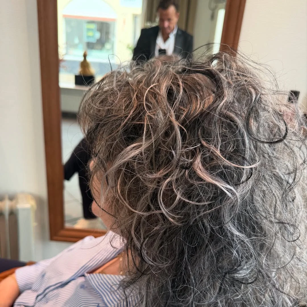flattering summer haircuts for women over 60 2026 Curly Gray Crop With Rose-Toned Highlights