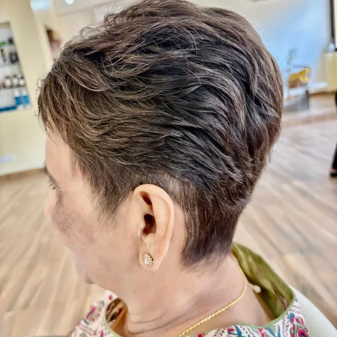 flattering summer haircuts for women over 60 2026 Textured Brunette Pixie With Tapered Sides