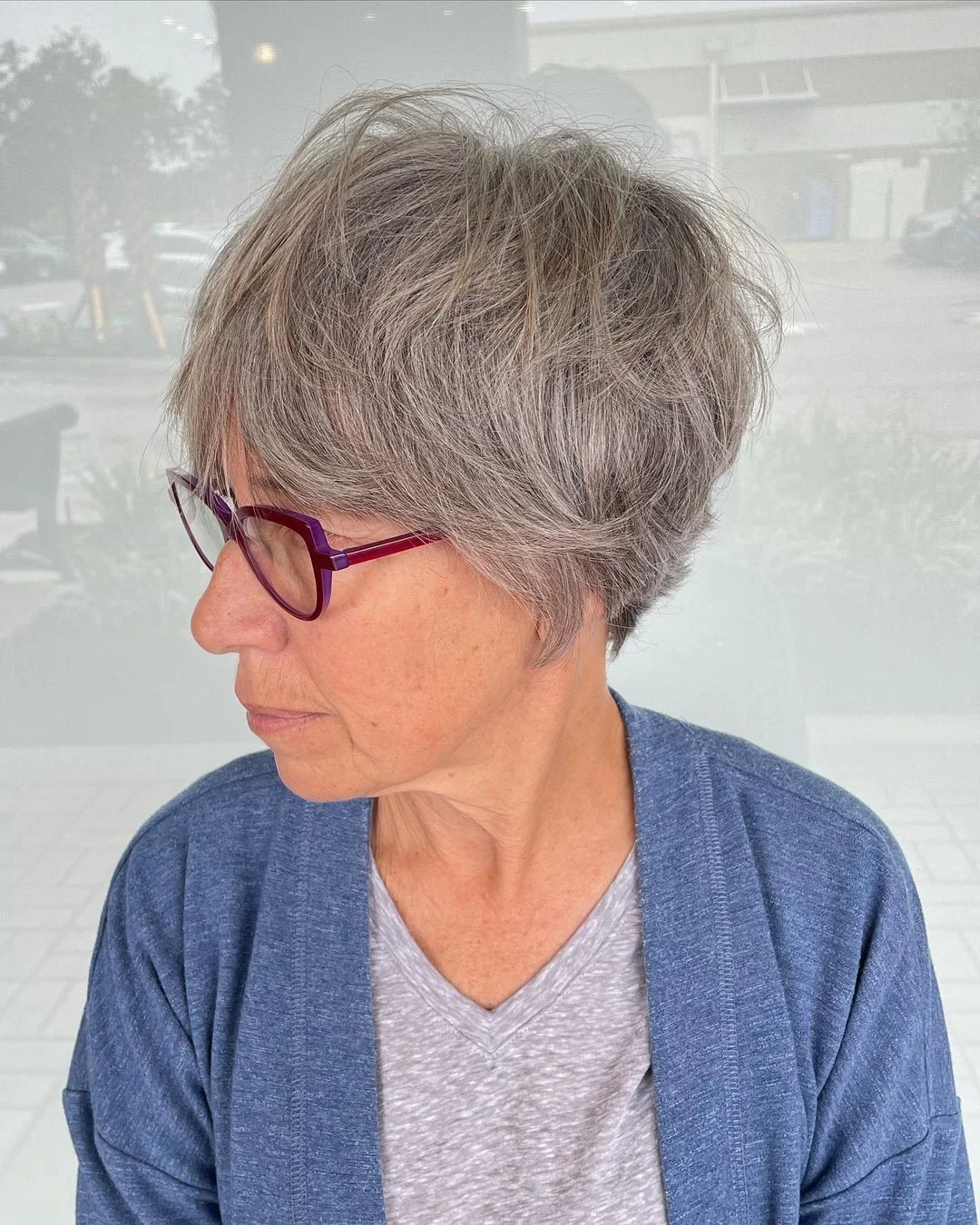 flattering summer haircuts for women over 60 2026 Airy Gray Pixie With Wispy Bangs