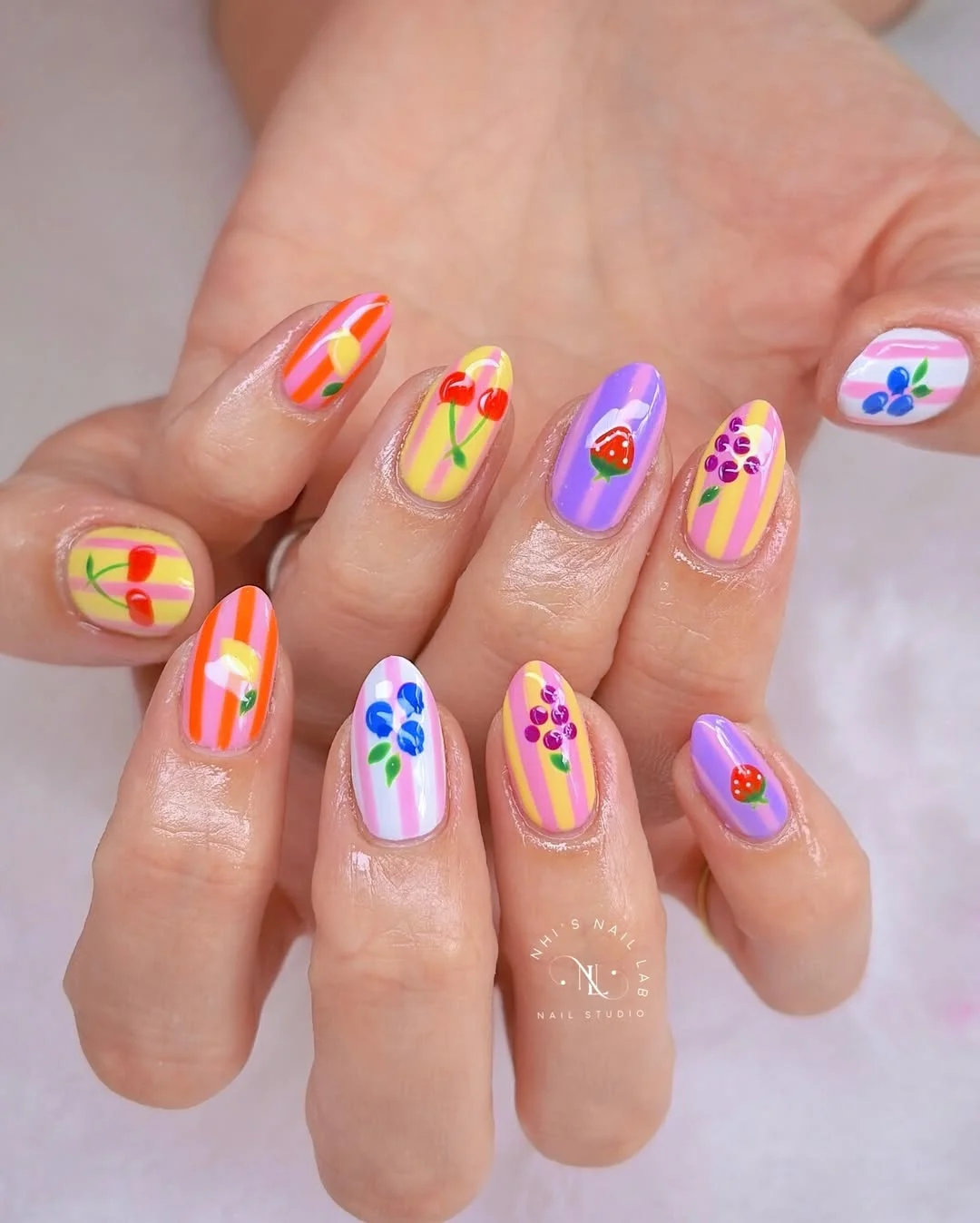 light summer nails 2026 Striped Fruit Nails With Purple Blue Yellow And Pink Details