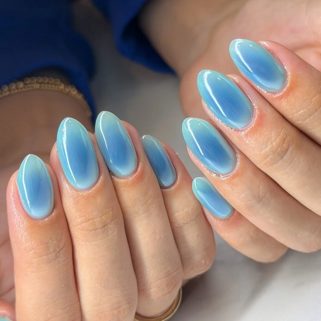 light summer nails 2026 Glossy Light Blue Aura Nails With A Watery Summer Finish