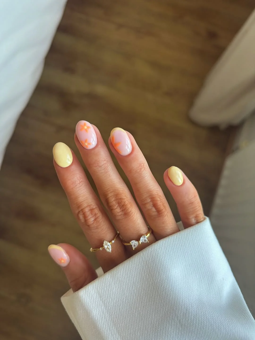 light summer nails 2026 Soft Lemon And Orange Flower Nails With A Sheer Summer Base