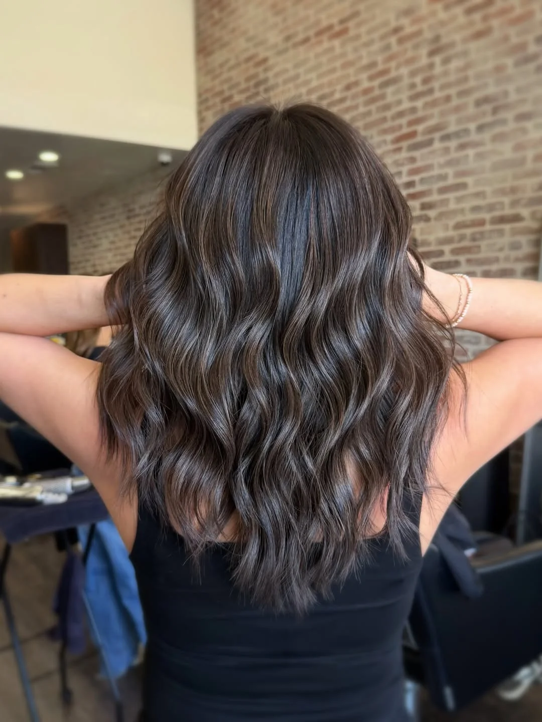low maintenance summer hair color for brunettes Cool Charcoal Brunette With Soft Beachy Texture