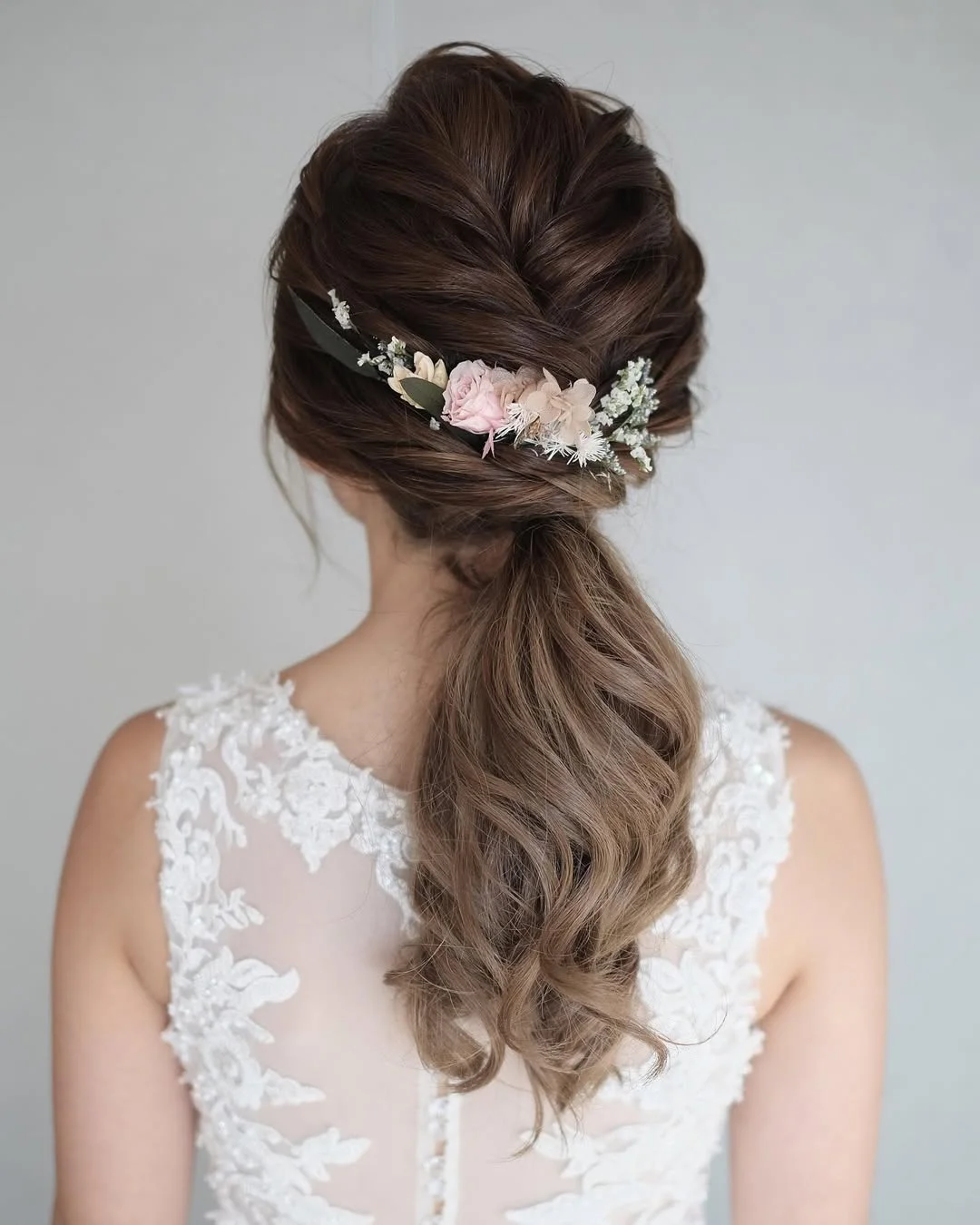 low summer ponytail hairstyle 2026 Floral Low Ponytail with Soft Bridal Volume