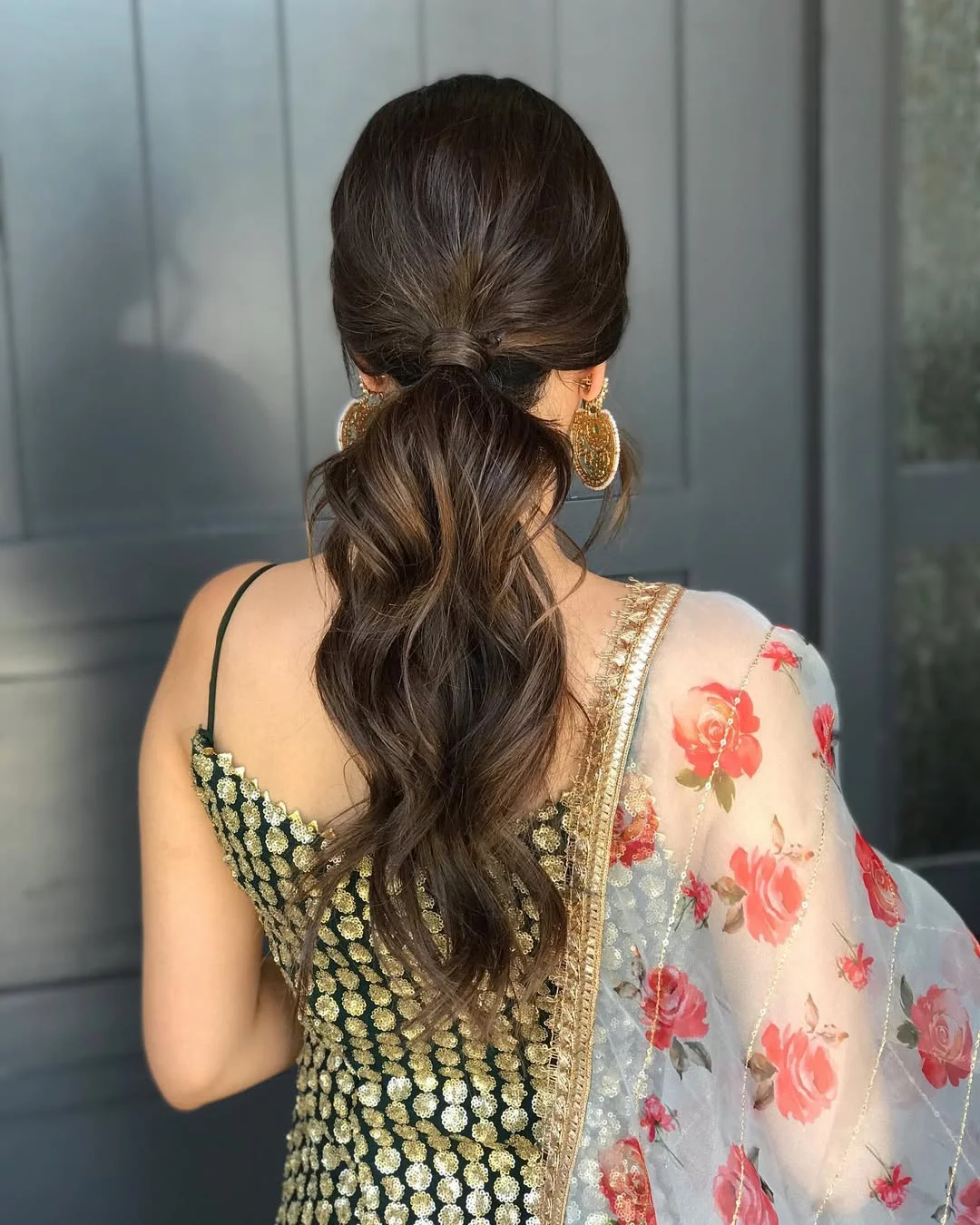 low summer ponytail hairstyle 2026 Soft Black Low Ponytail with Loose Romantic Waves