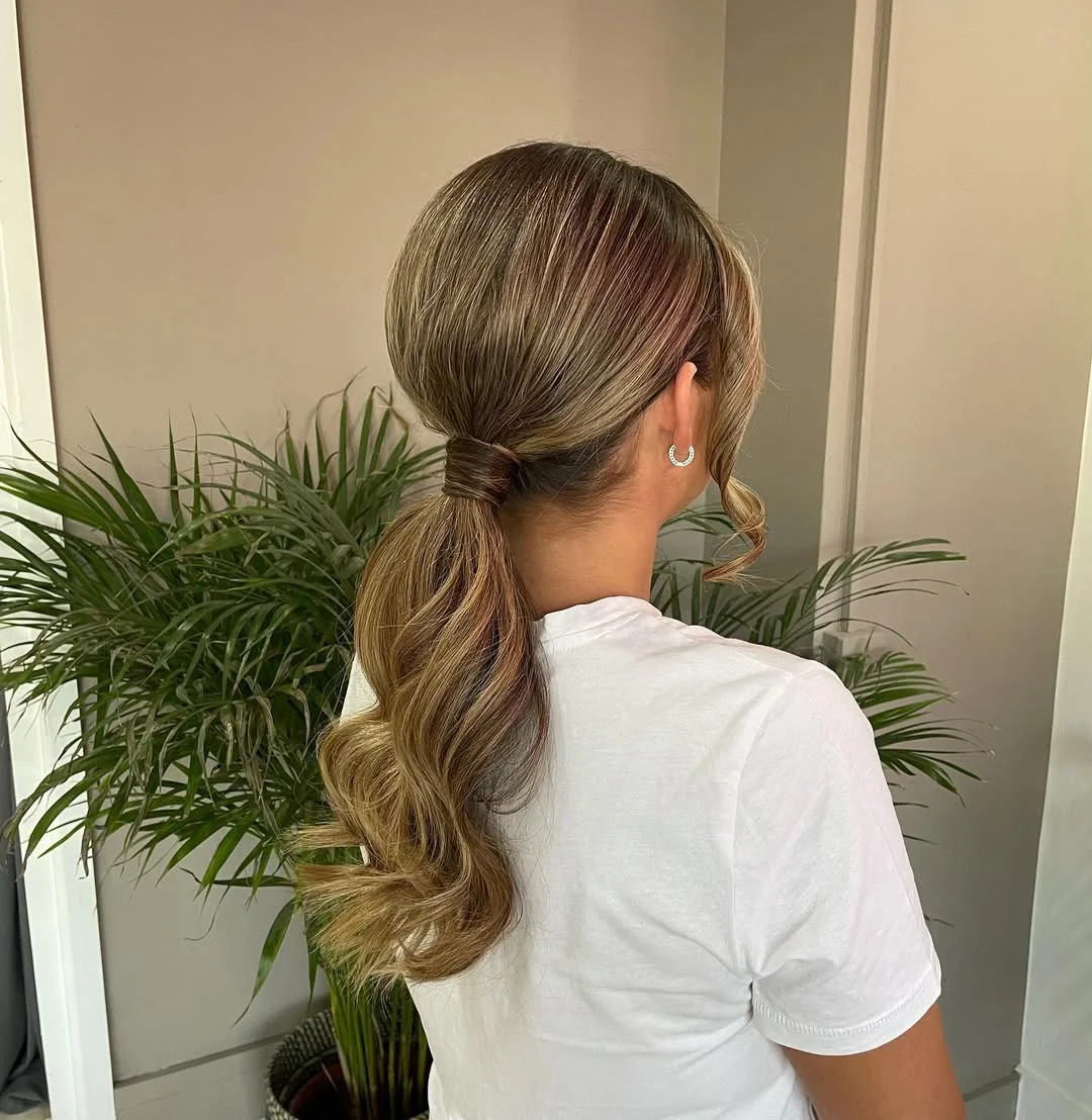 low summer ponytail hairstyle 2026 Soft Blonde Low Ponytail with Face-Framing Curl