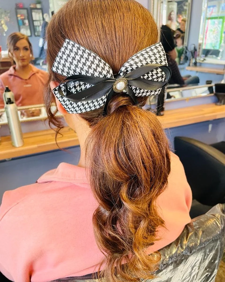 low summer ponytail hairstyle 2026 Bow-Tied Low Ponytail with Playful Retro Energy