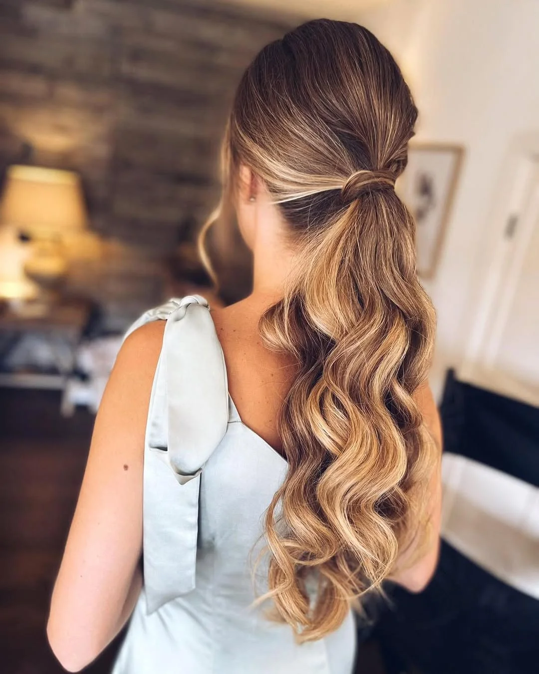 low summer ponytail hairstyle 2026 Glossy Blonde Low Ponytail with Defined Waves
