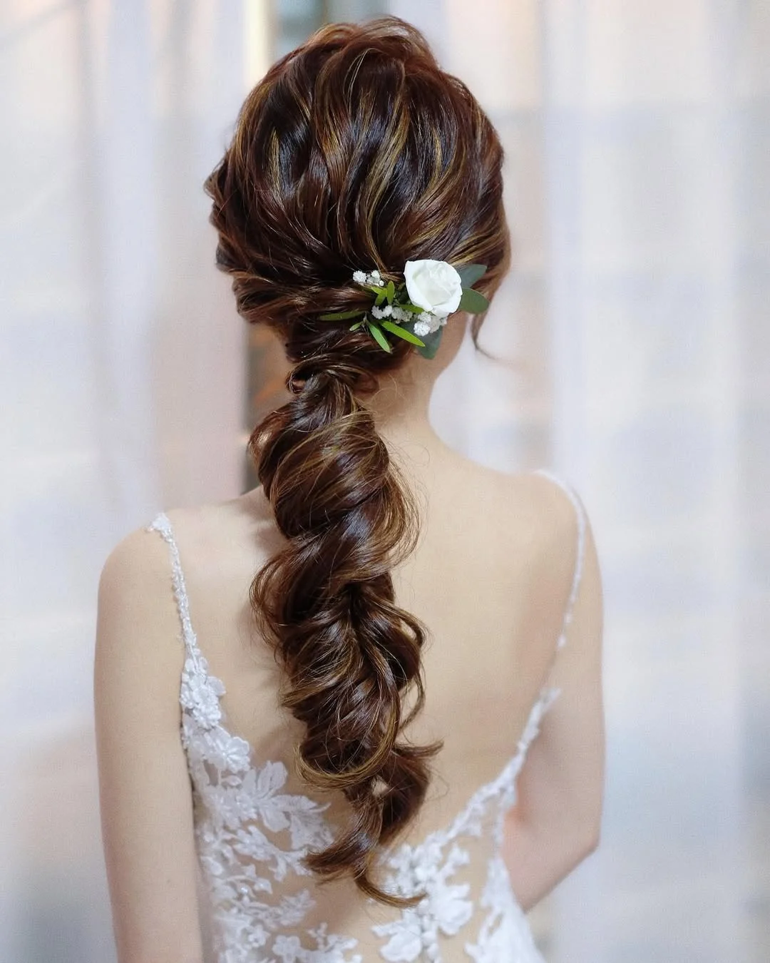 low summer ponytail hairstyle 2026 Romantic Side-Swept Ponytail with Floral Detail