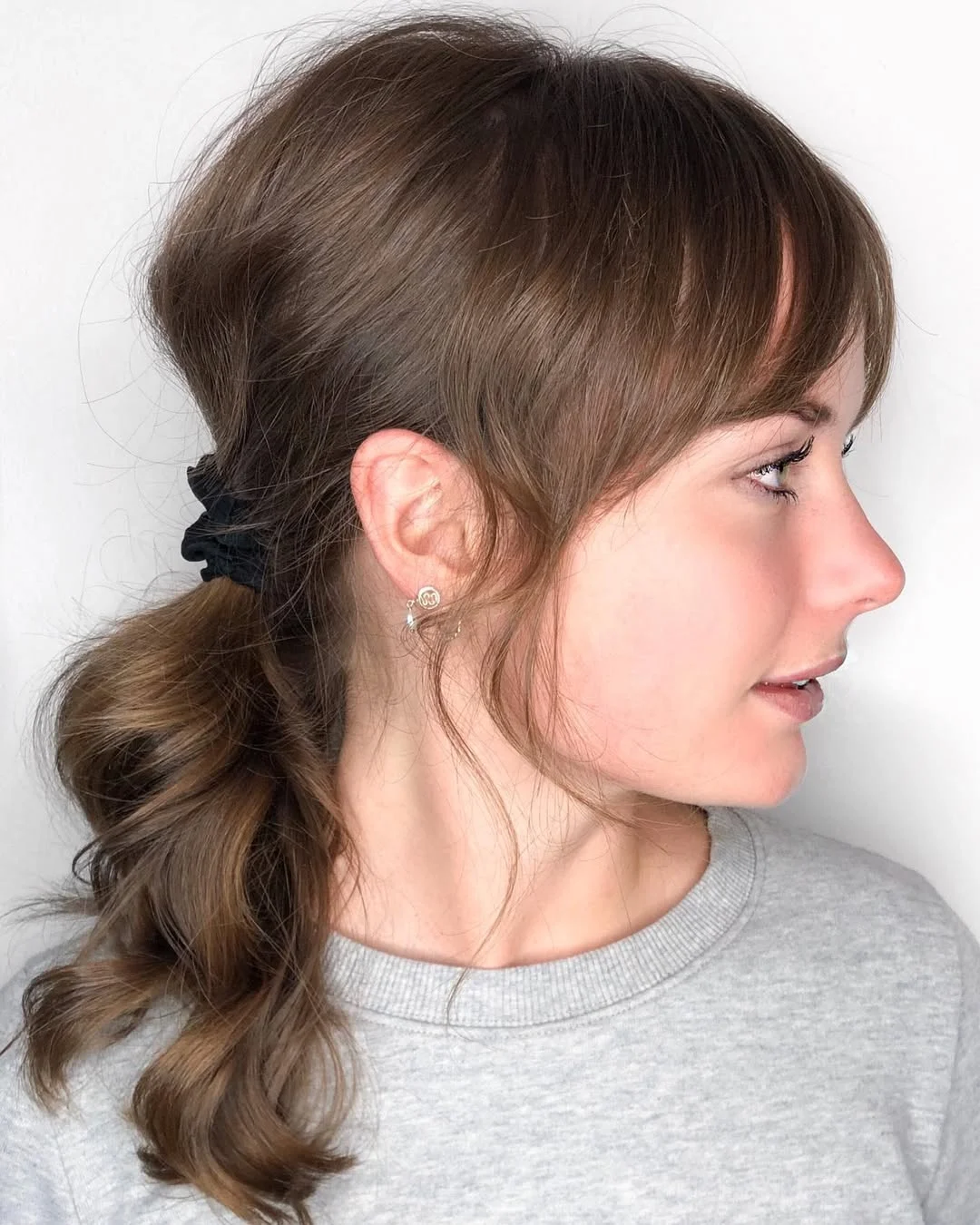 low summer ponytail hairstyle 2026 Low Ponytail with Soft Bangs and Everyday Polish