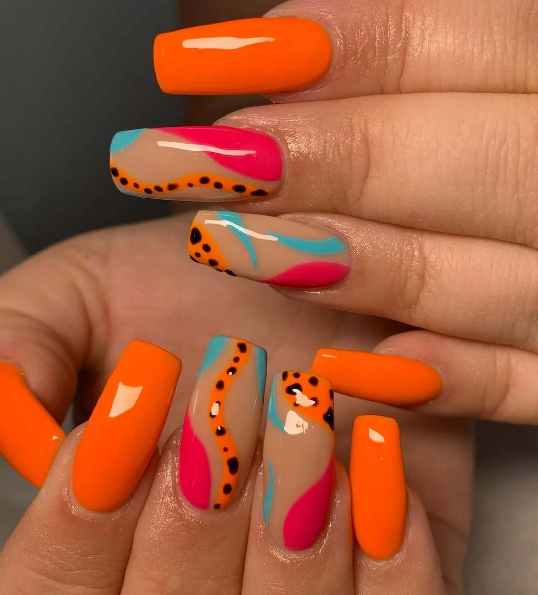 neon summer nails 2026 Neon Orange Square Nails with Abstract Pink and Blue Art