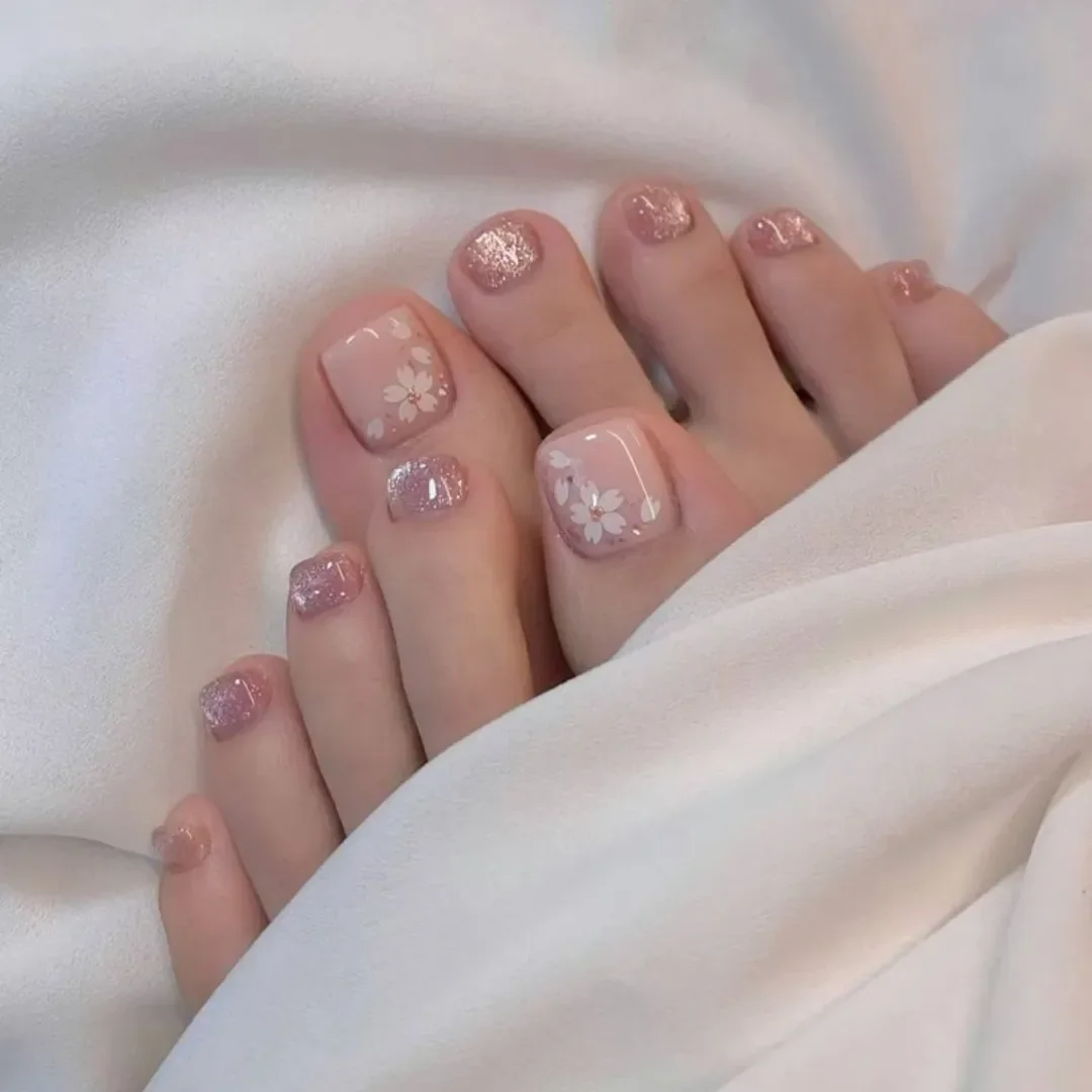 pedicure ideas - summer trends 2026 Blush Floral Pedicure With Soft Glitter Accents