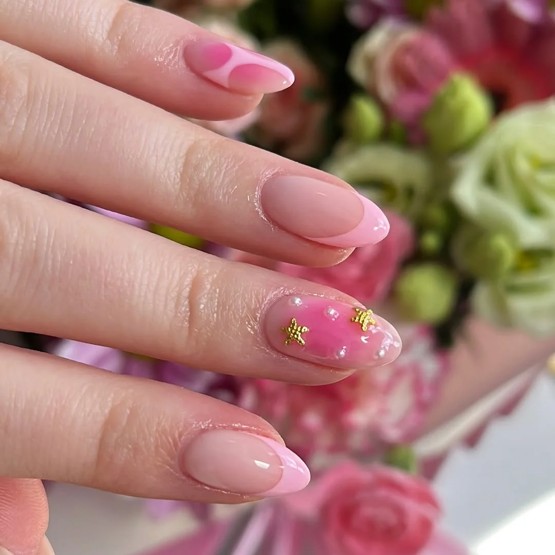 pink summer nails 2026 Soft Pink Almond Nails With Tiny Gold Stars