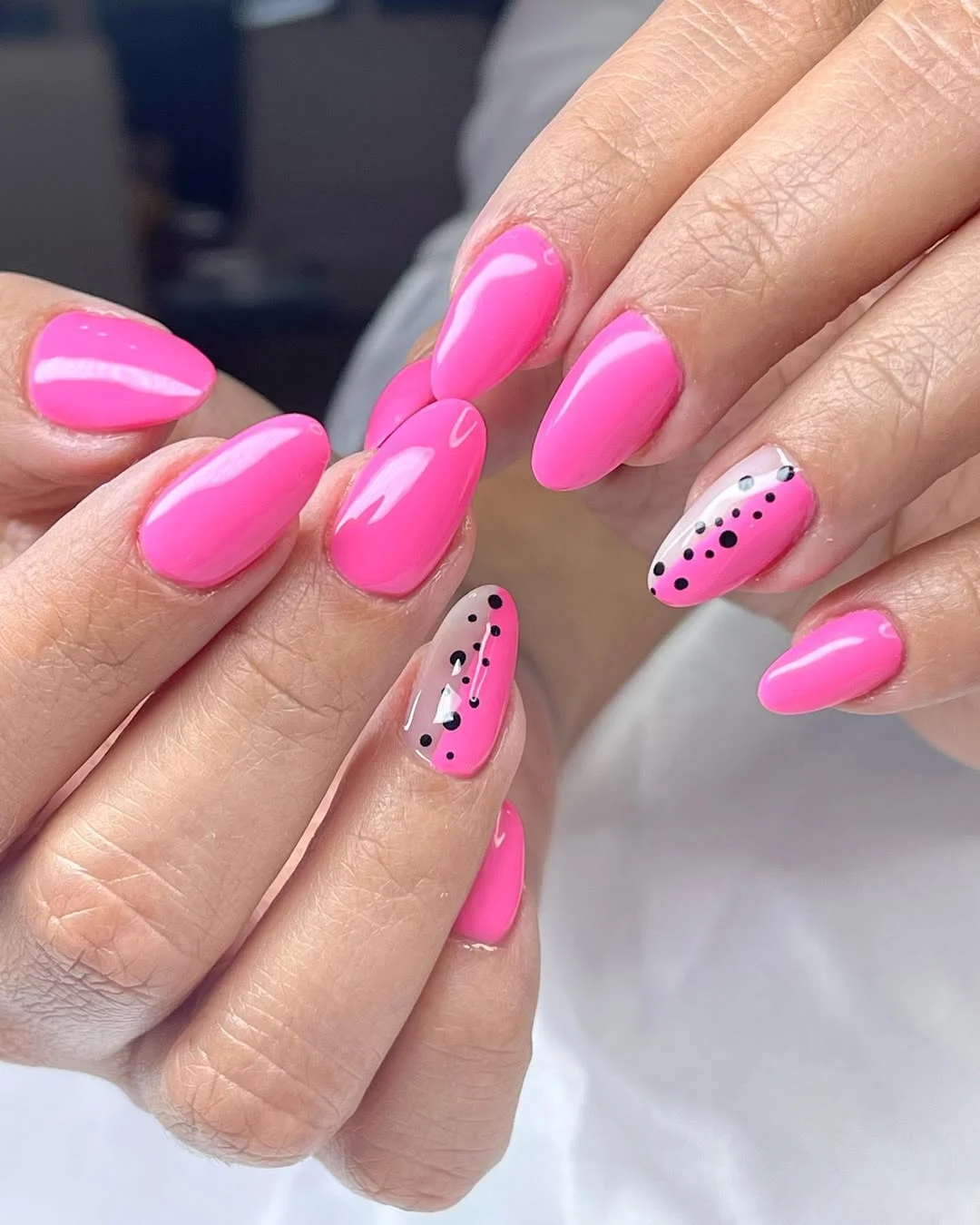 pink summer nails 2026 Glossy Pink Almond Nails With Black Dot Accents