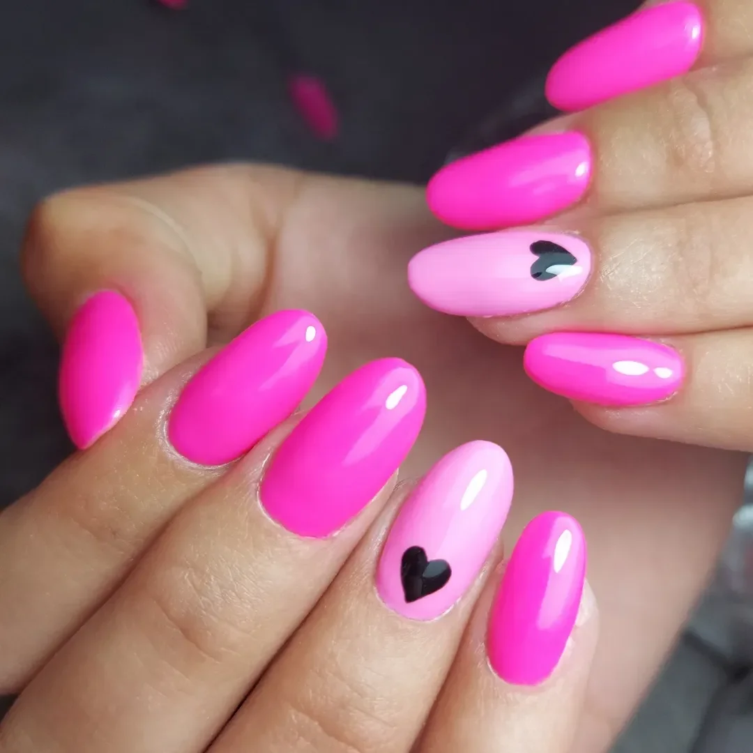 pink summer nails 2026 Glossy Hot Pink Almond Nails With Tiny Black Hearts