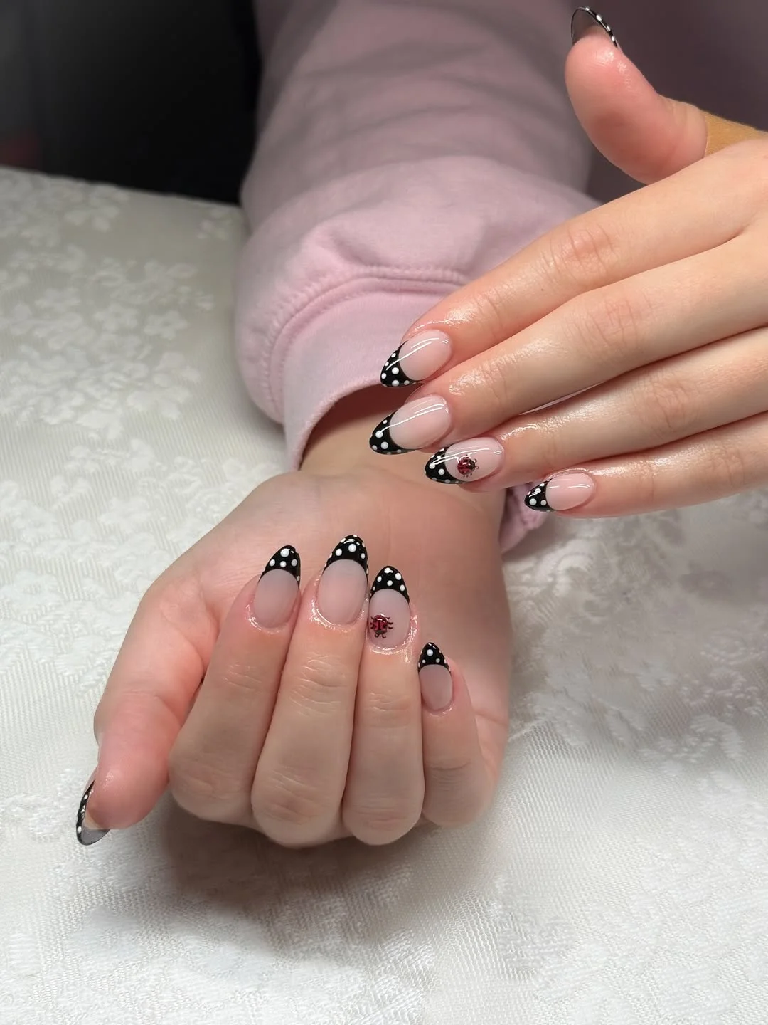 polka dot summer nails 2026 Black Polka Dot French Tips With Tiny Ladybug Charm