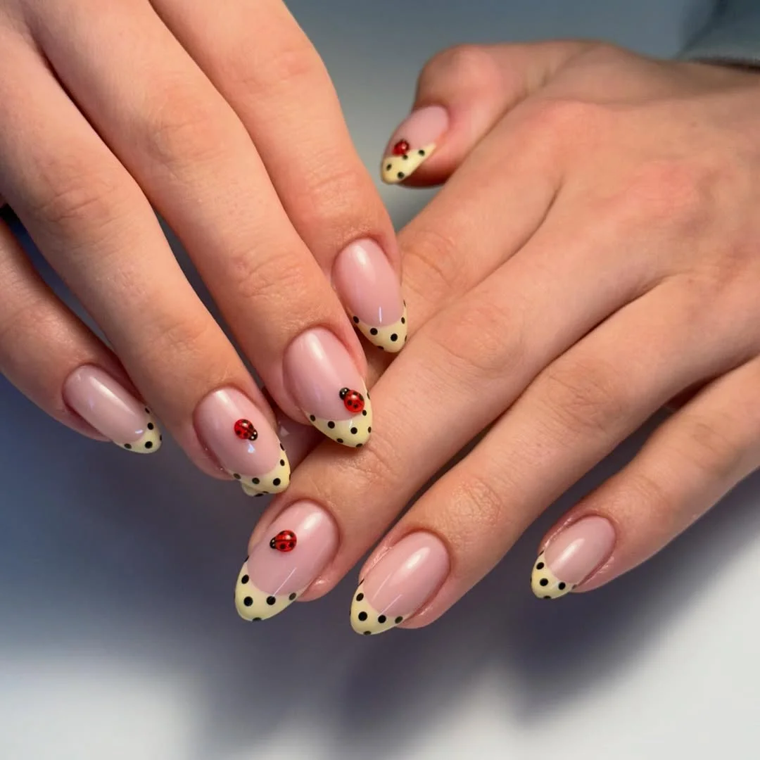 polka dot summer nails 2026 Yellow French Tips With Black Dots And Tiny Ladybug Accents