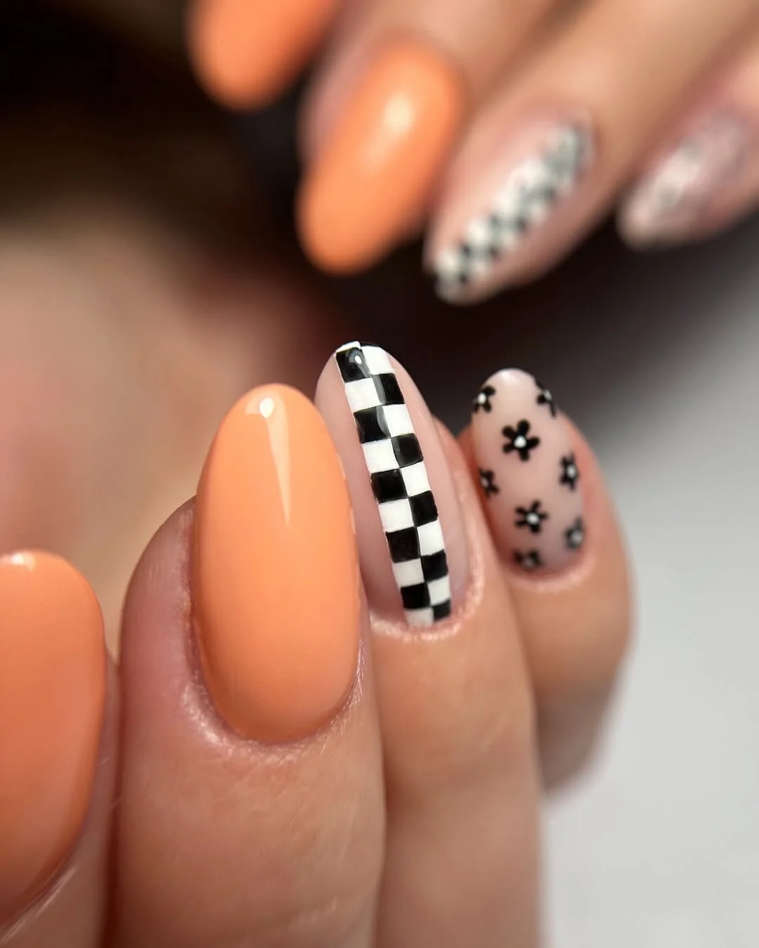 short gel nails summer 2026 Peach Checkerboard Nails With Tiny Black Floral Accents