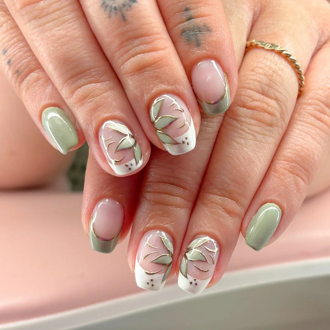 short gel nails summer 2026 Sage Botanical Nails With White French Accents And Fine Gold Details