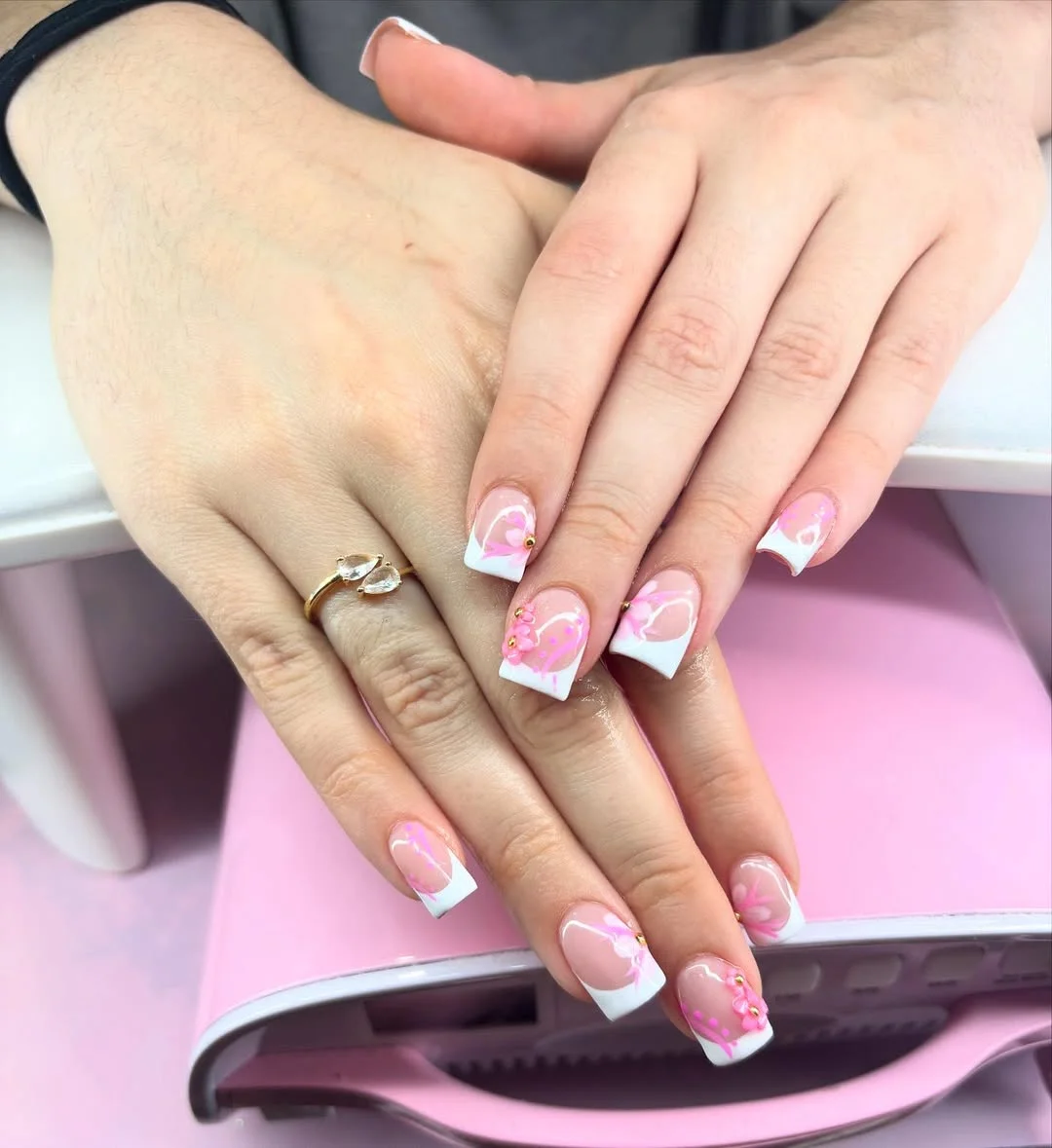 short gel nails summer 2026 Soft White French Gel Nails With Pink Swirls And Gold Studs