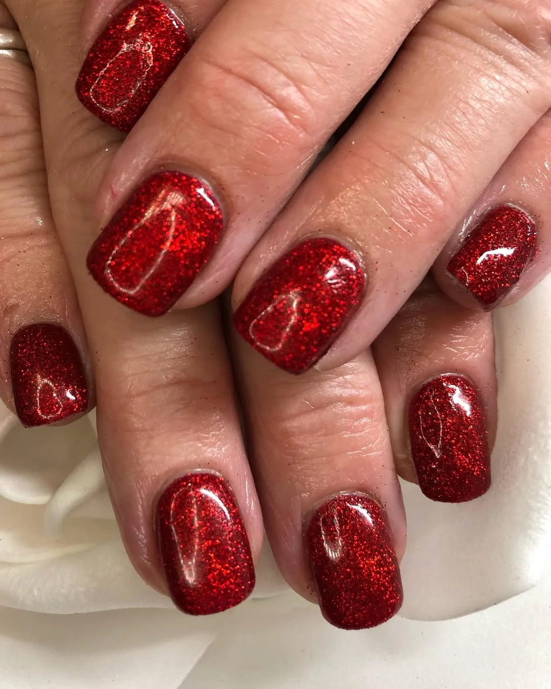 short squoval nails design 2026 Red Glitter Squoval Nails with a Party Shine