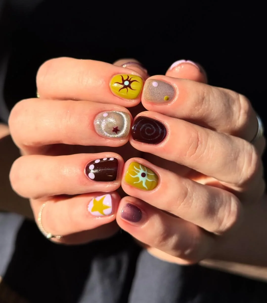 short summer nails 2026 Moody Sun And Star Art On Short Round Nails