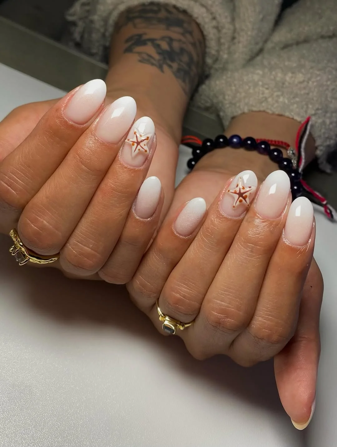summer beach nails 2026 Milky White Starfish Nails With a Soft Coastal Glow