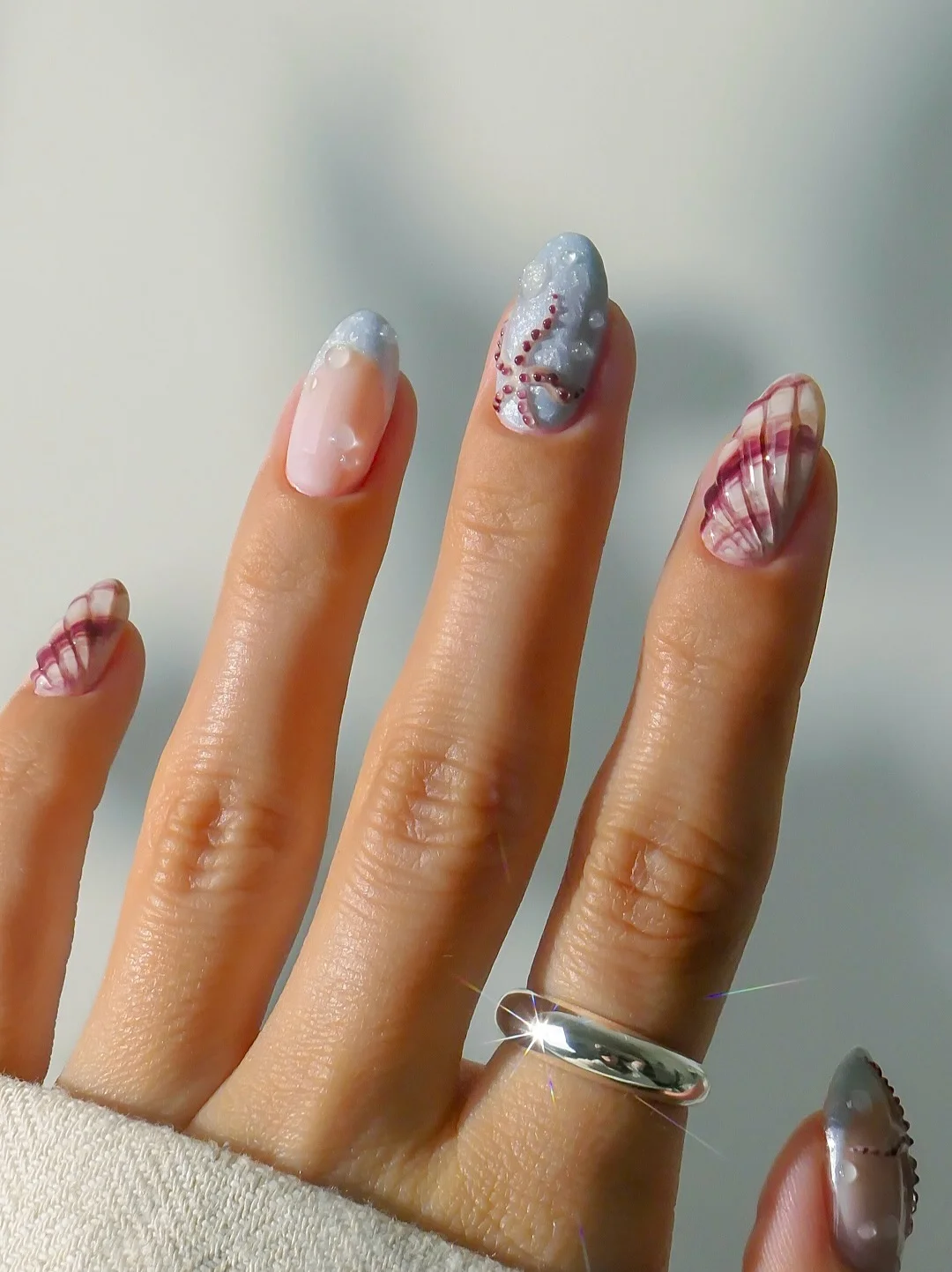 summer beach nails 2026 Textured Seashell Nails With Moody Coastal Details