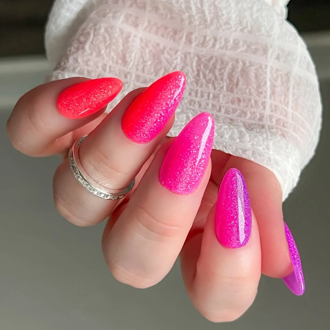 summer dip nails 2026 Hot Pink Sparkle Almond Nails With A Purple Twist