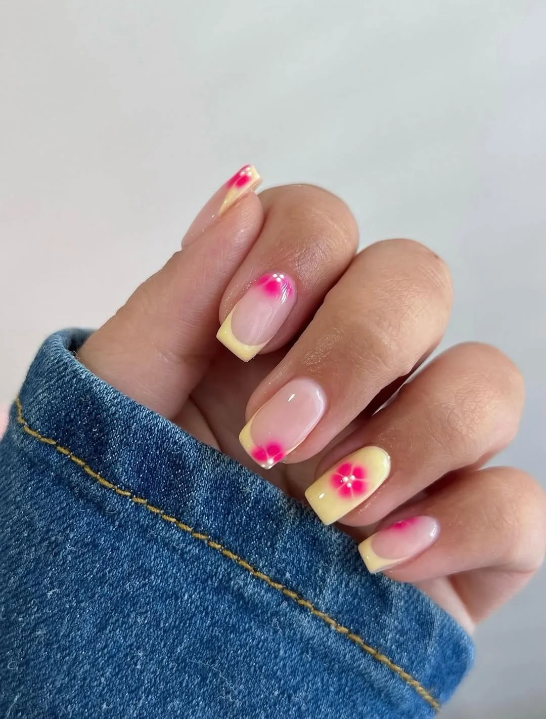 summer dip nails 2026 Yellow French Tips With Pink Flower Accents