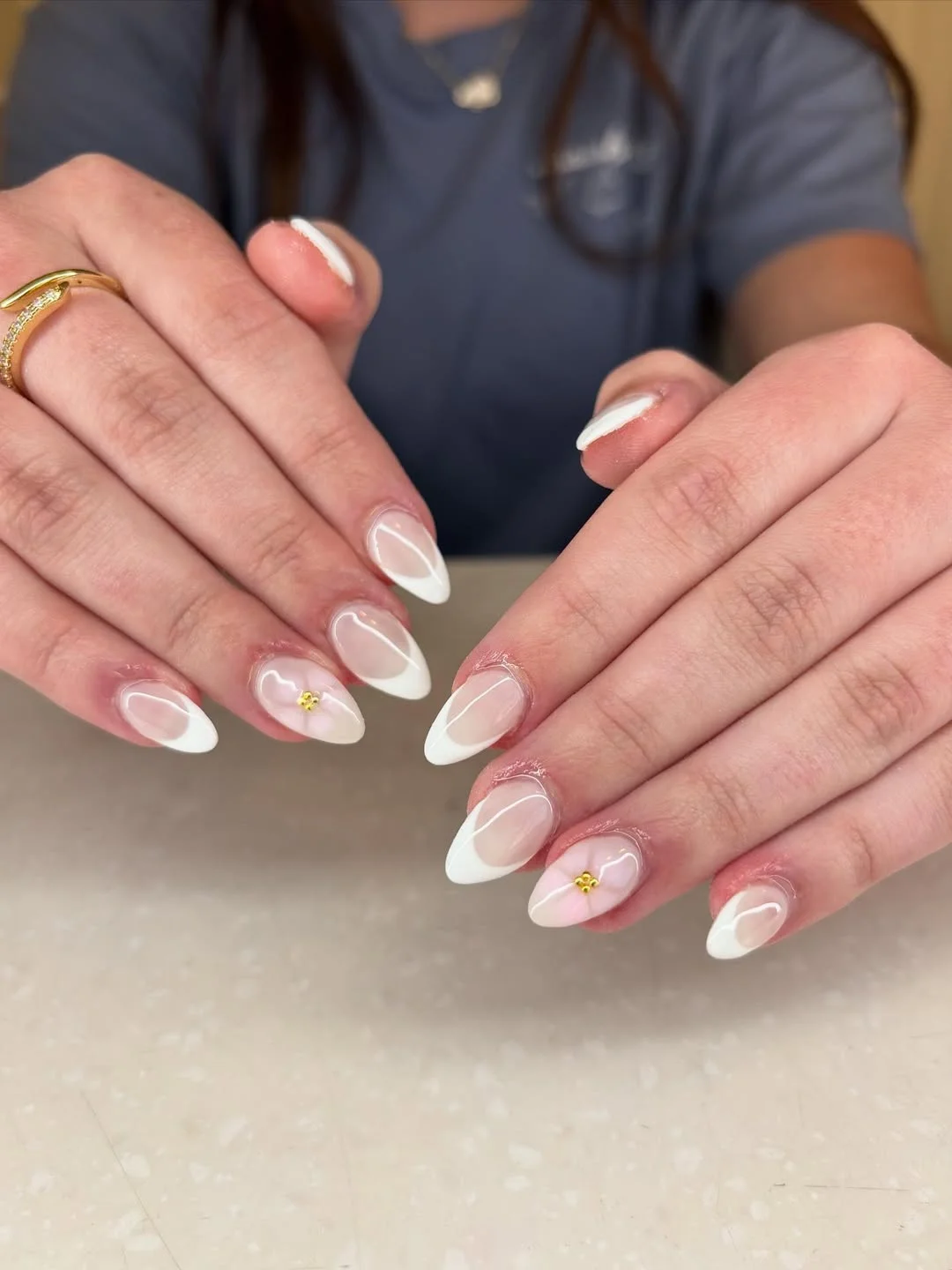 summer french nails ideas 2026 Almond French Nails With Tiny Gold Flower Art