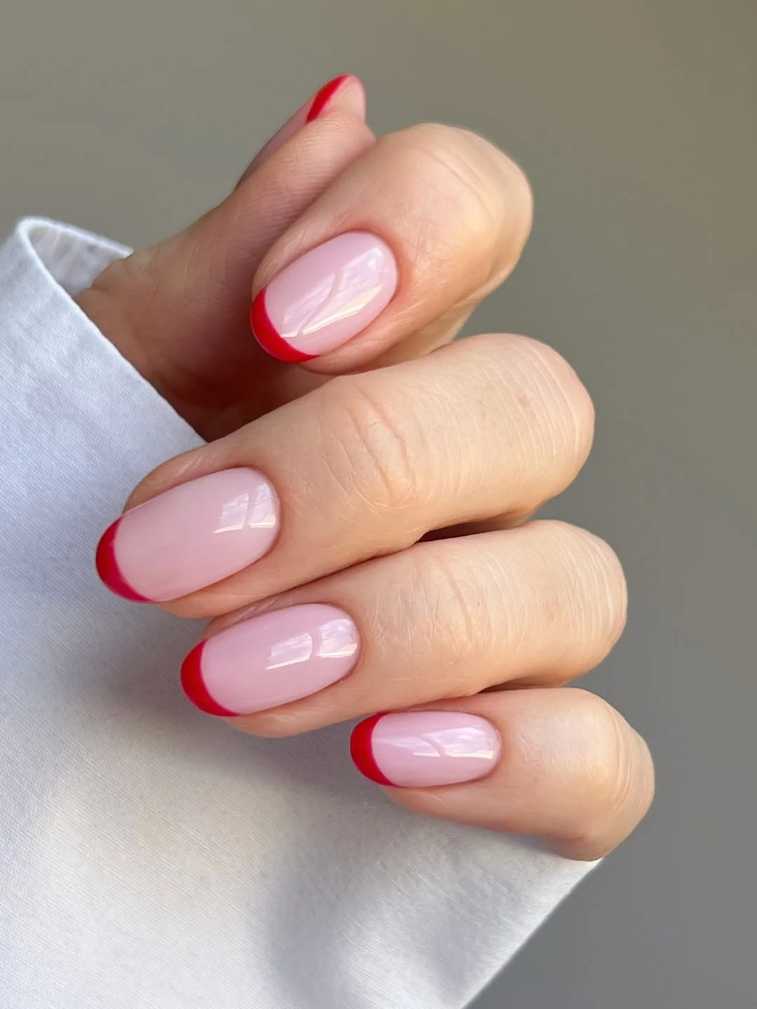summer french nails ideas 2026 Bright Red French Tips On Glossy Almond Nails