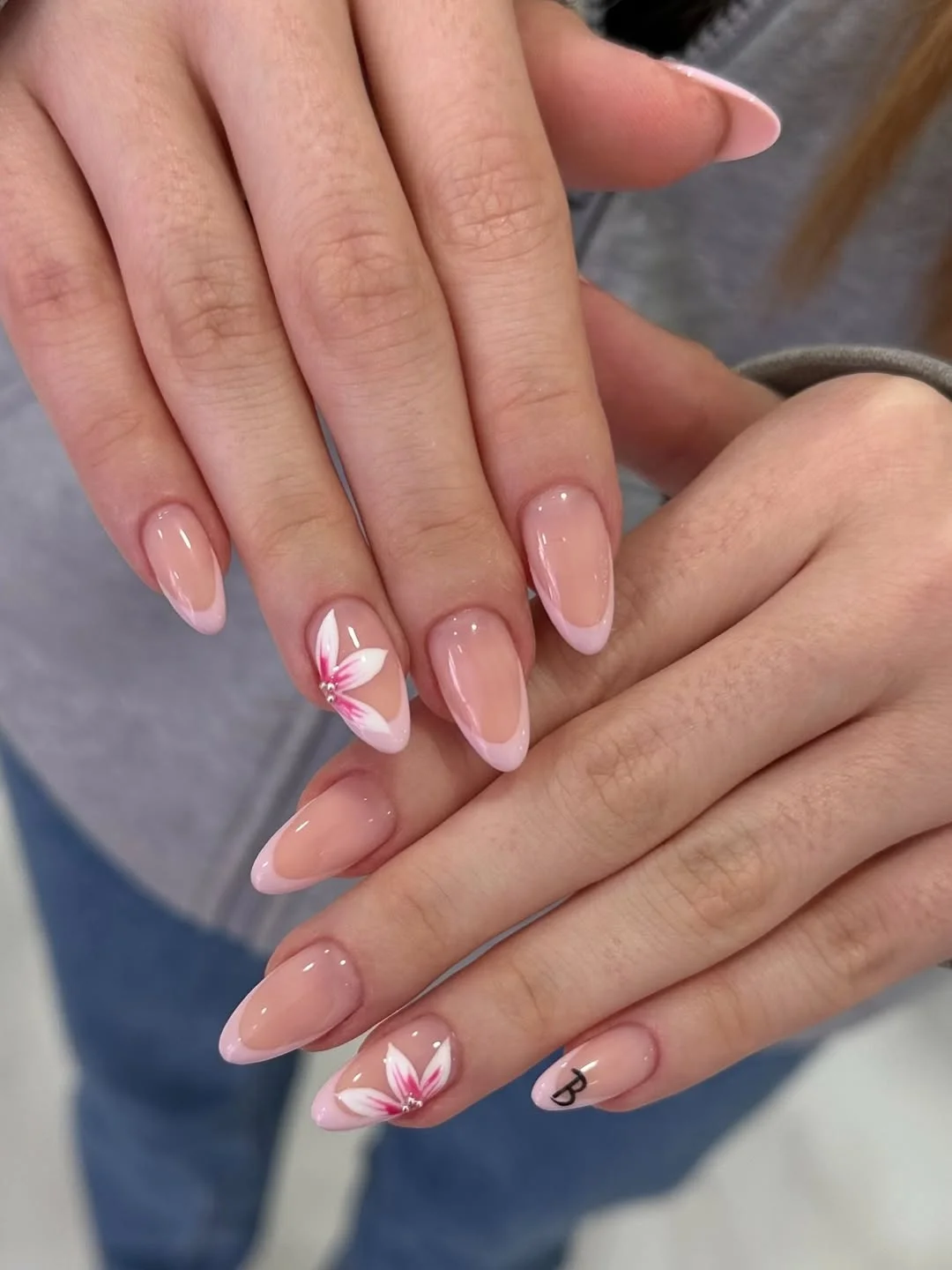 summer french tip nails 2026 Pink Almond French Tips With Floral Accent Nails
