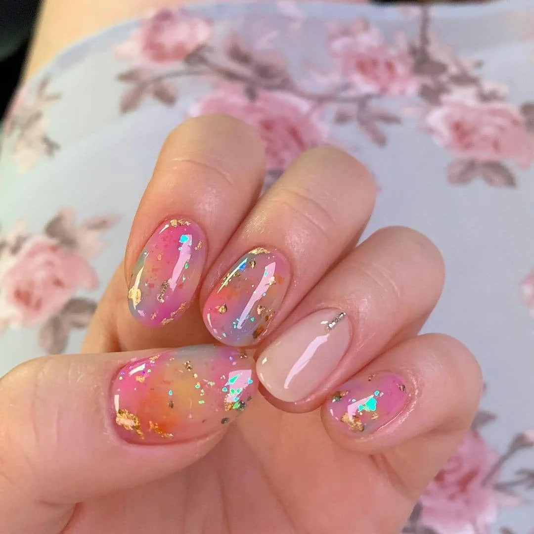 summer gel nails 2026 Sheer Pink Gel Nails With Gold Foil And Iridescent Sparkle