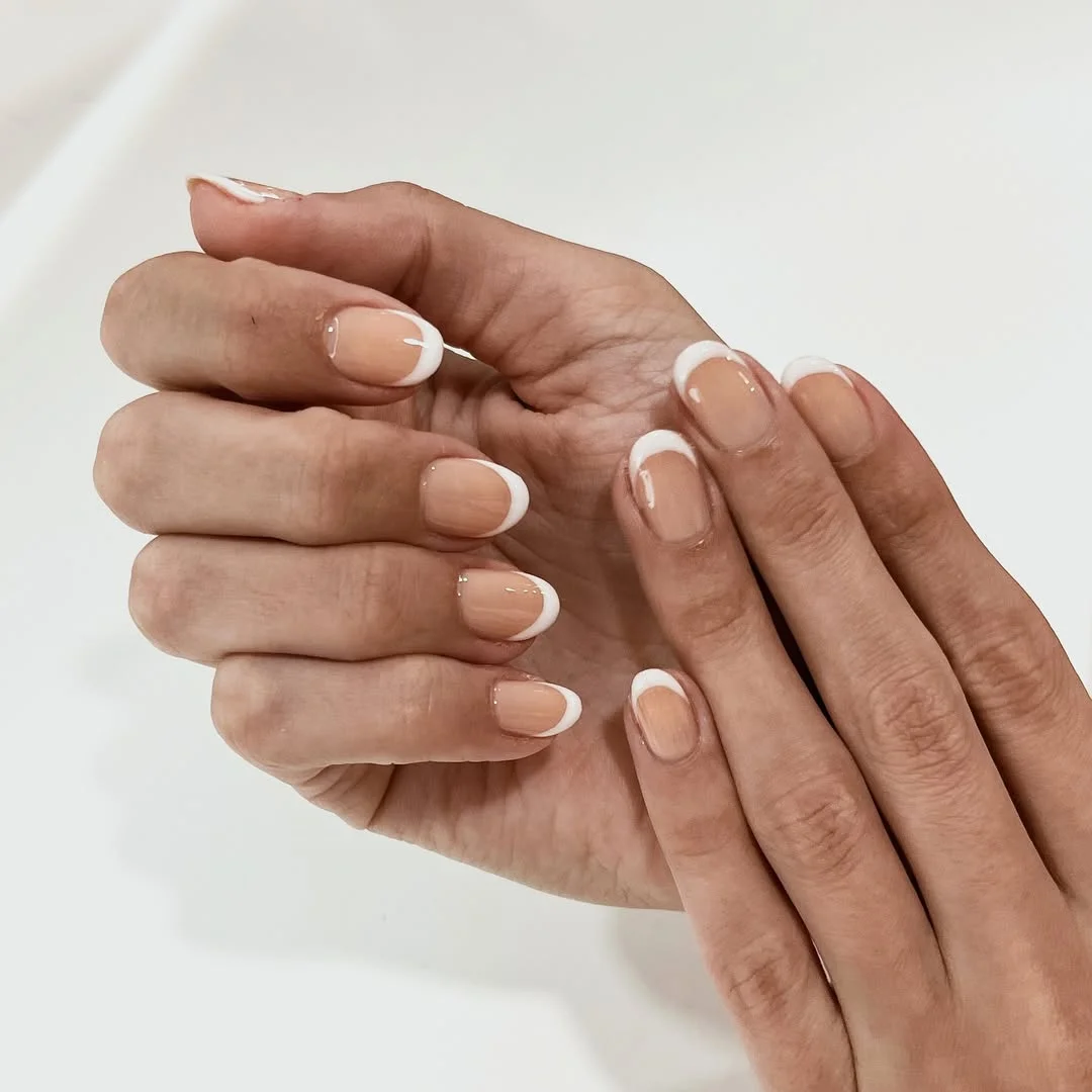 summer manicure color ideas 2026 Clean White French Tips On A Nude Base