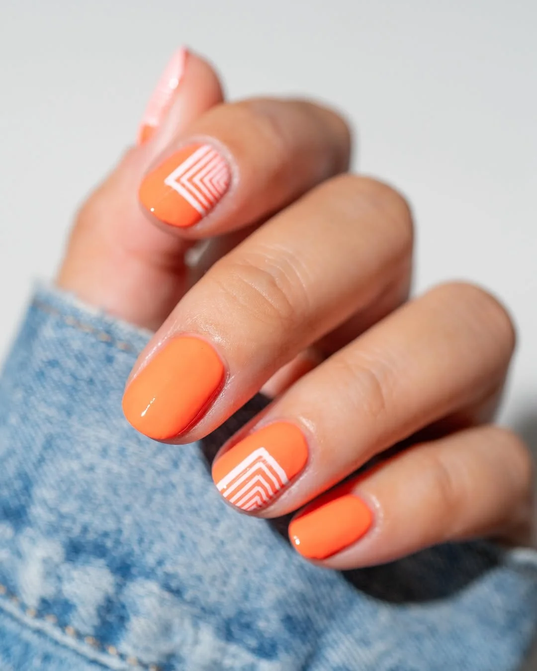 summer manicure color ideas 2026 Glossy Orange Nails With Clean White Line Art