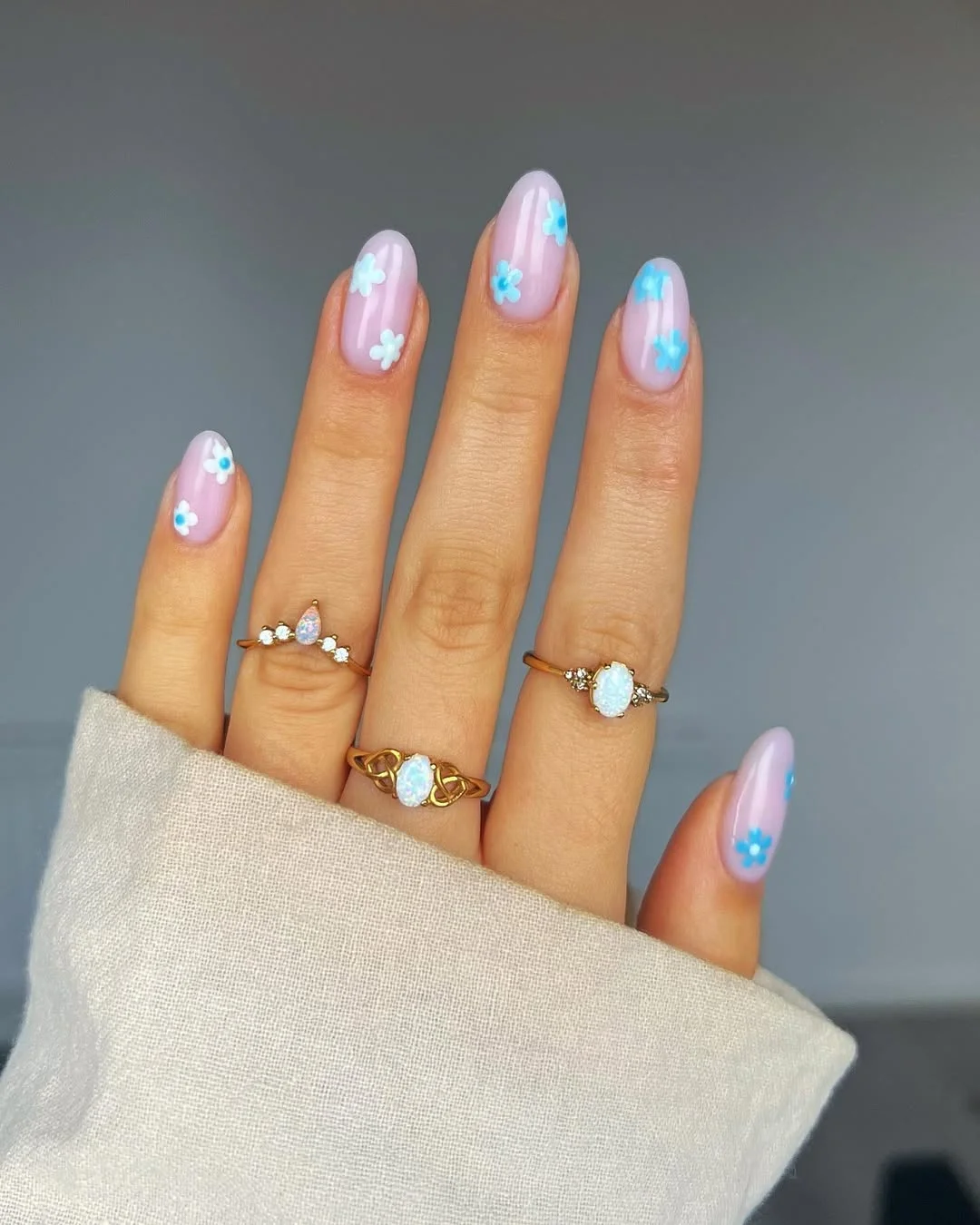 summer nail inspo 2026 Soft Pink Almond Nails With Tiny Blue Flowers