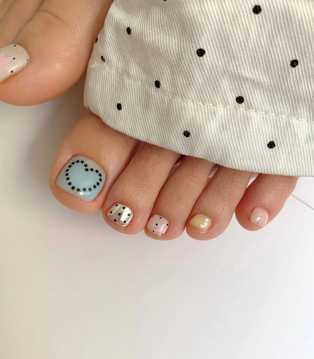 summer pedicure colors 2026 Pastel Mix With Tiny Black Dot Details