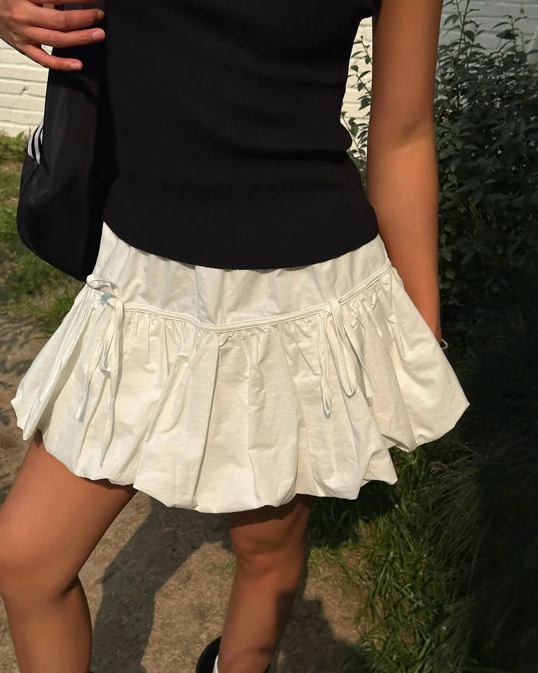 30 summer skirt outfits 2026 Black Knit Top With A Crisp White Bubble Skirt